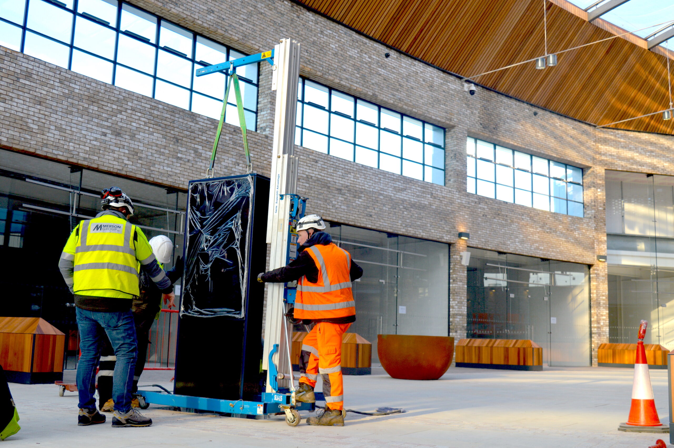 workers install a digital totem at Fosse Park Leicester